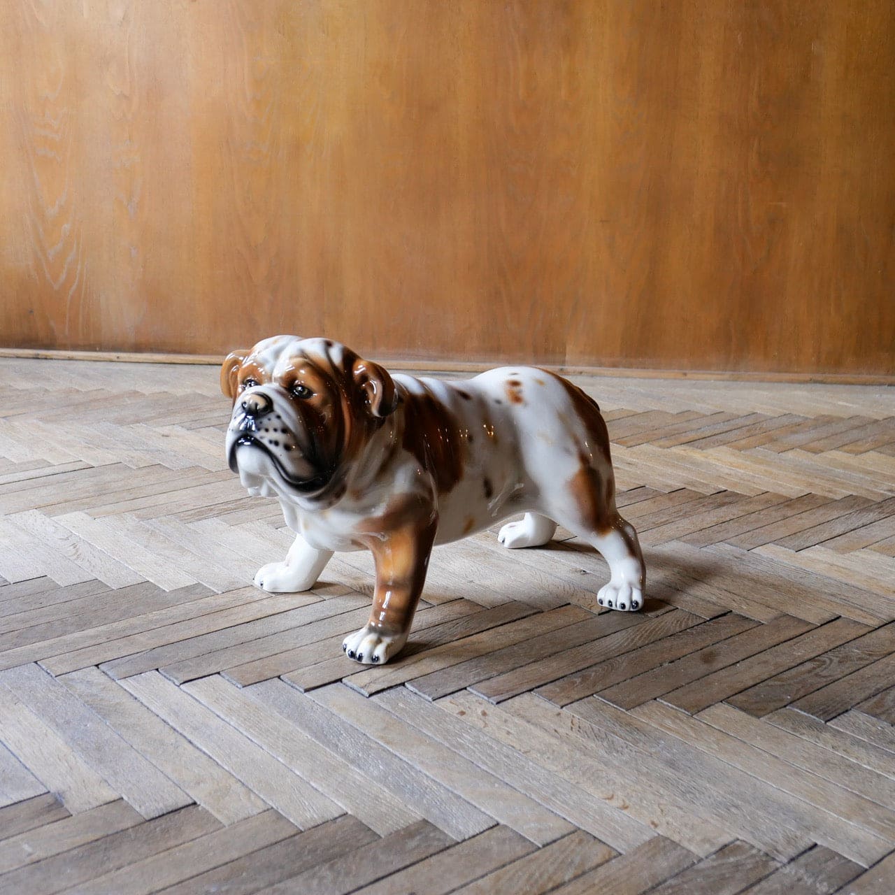 White ceramic bulldog sculpture with brown spots