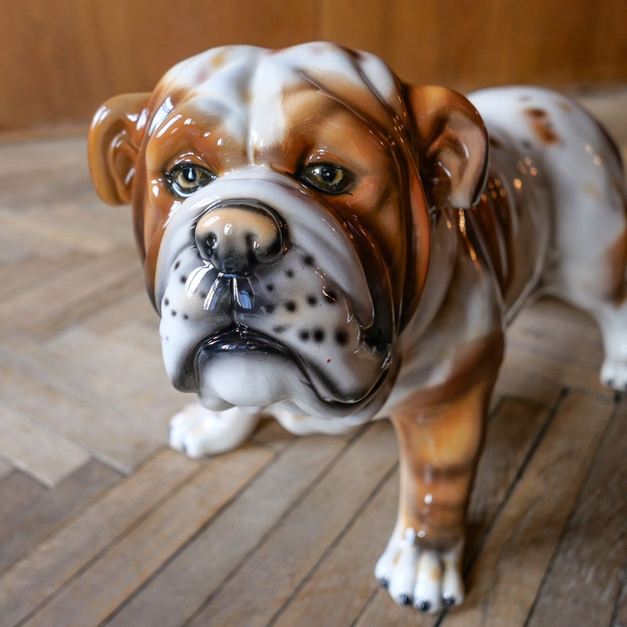 White ceramic bulldog sculpture with brown spots