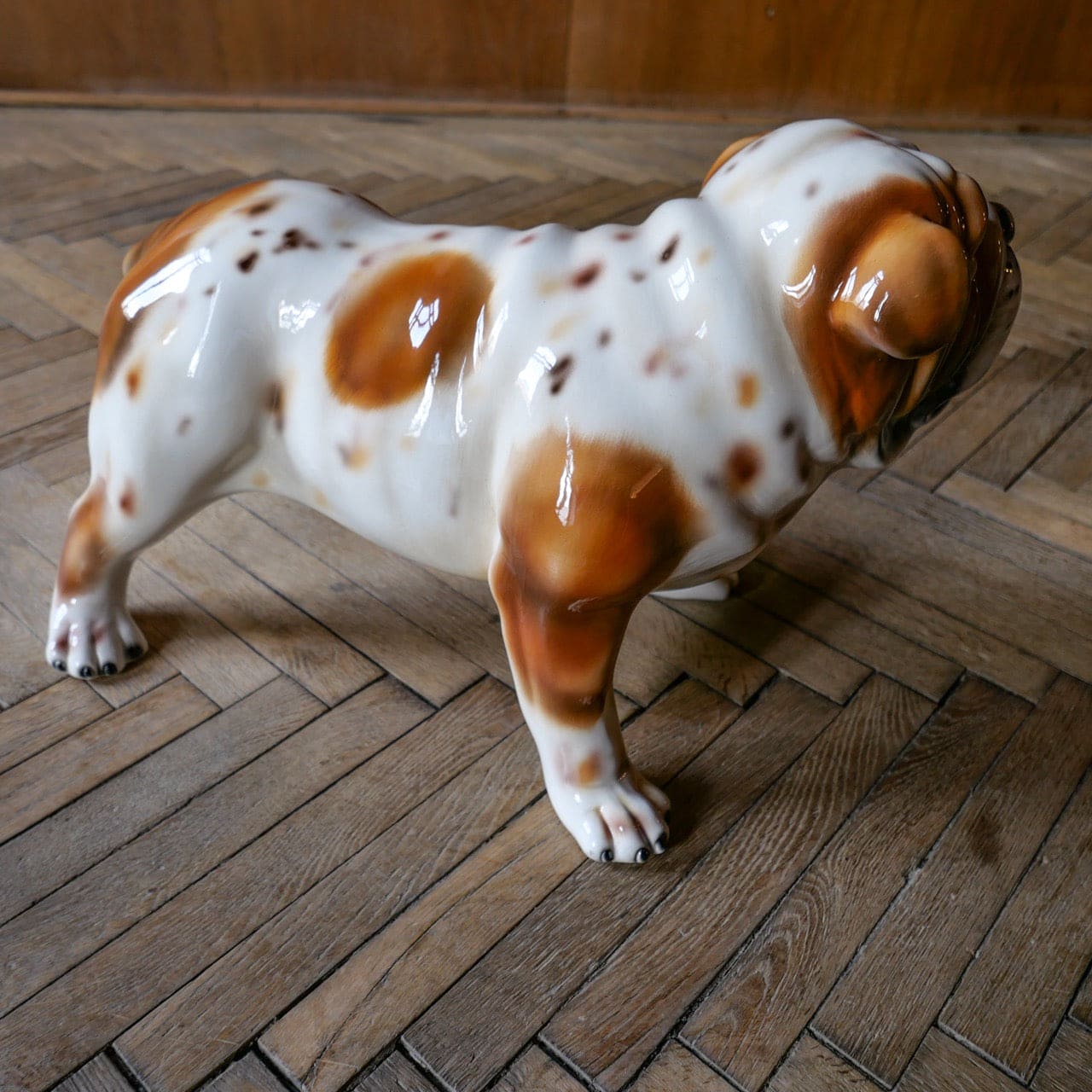 White ceramic bulldog sculpture with brown spots