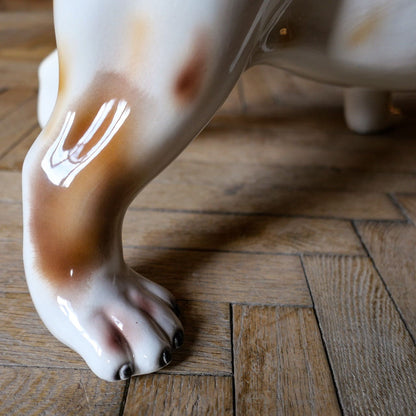 White ceramic bulldog sculpture with brown spots