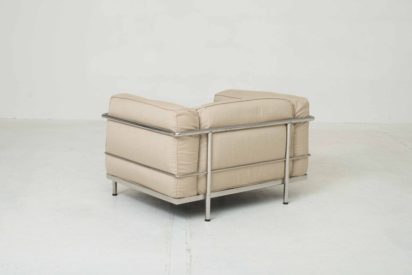 Cassina LC3 armchair by Le Corbusier in sand-colored fabric