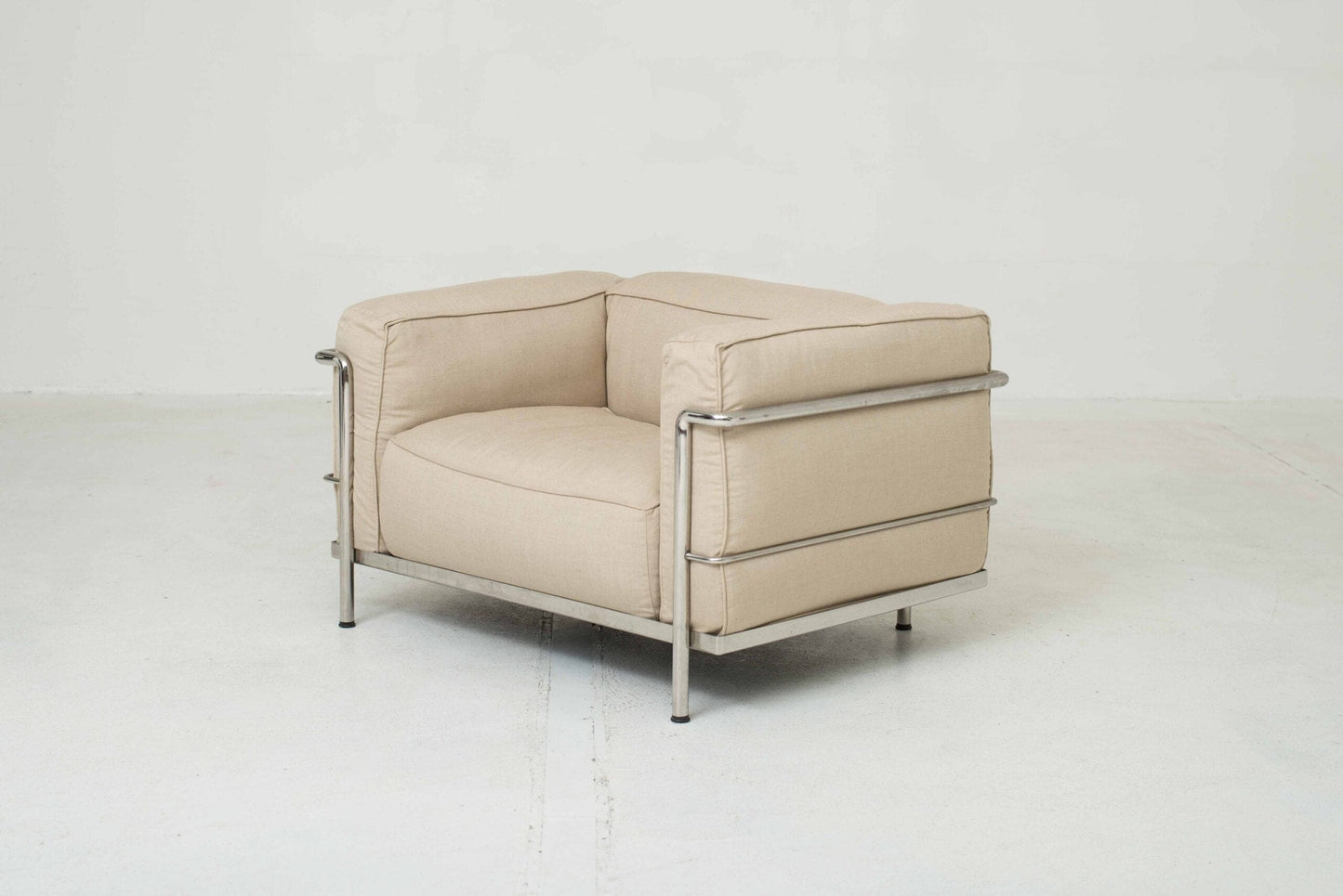 Cassina LC3 armchair by Le Corbusier in sand-colored fabric