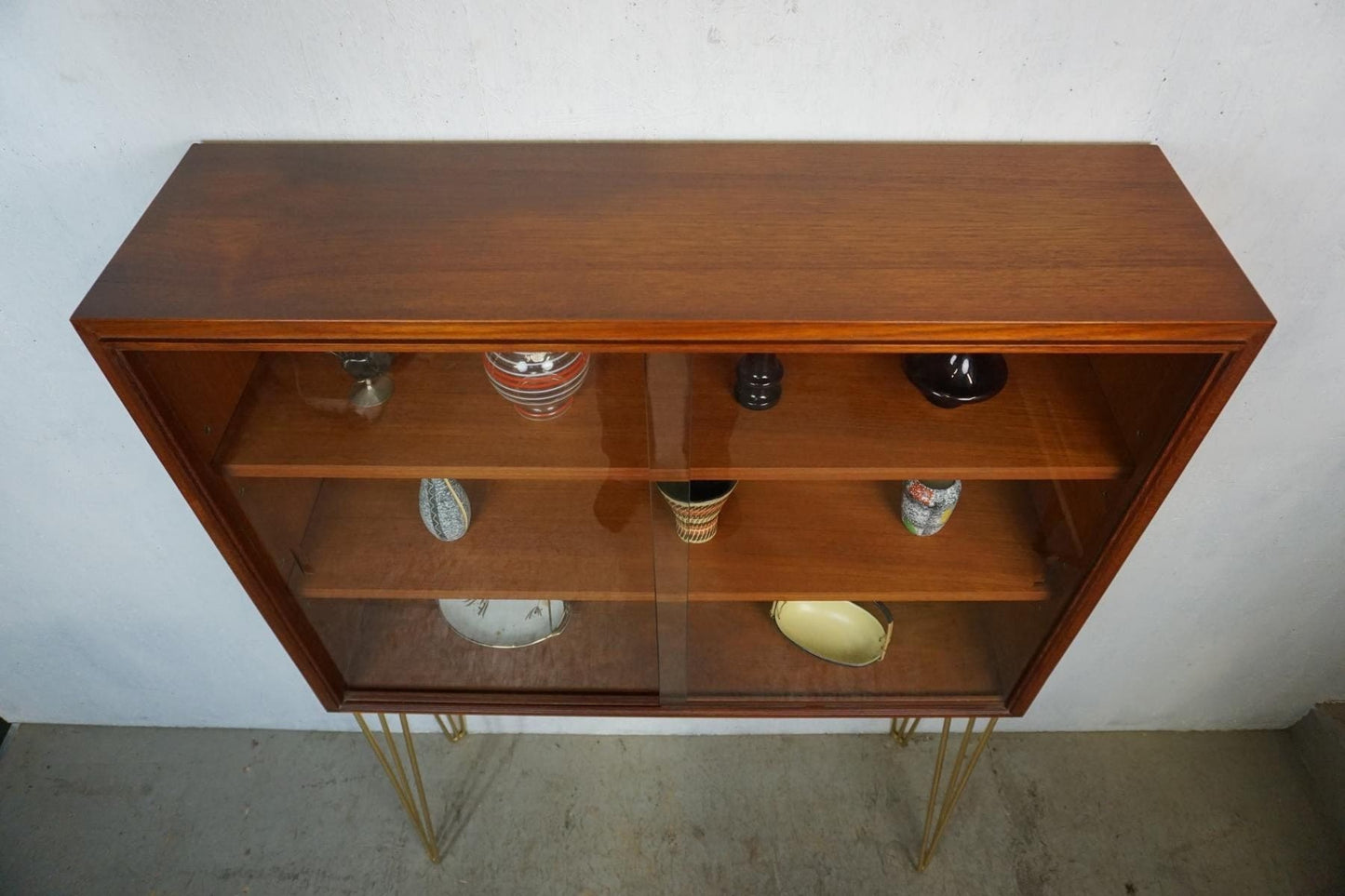 Noble teak display cabinet on golden hairpin legs vintage