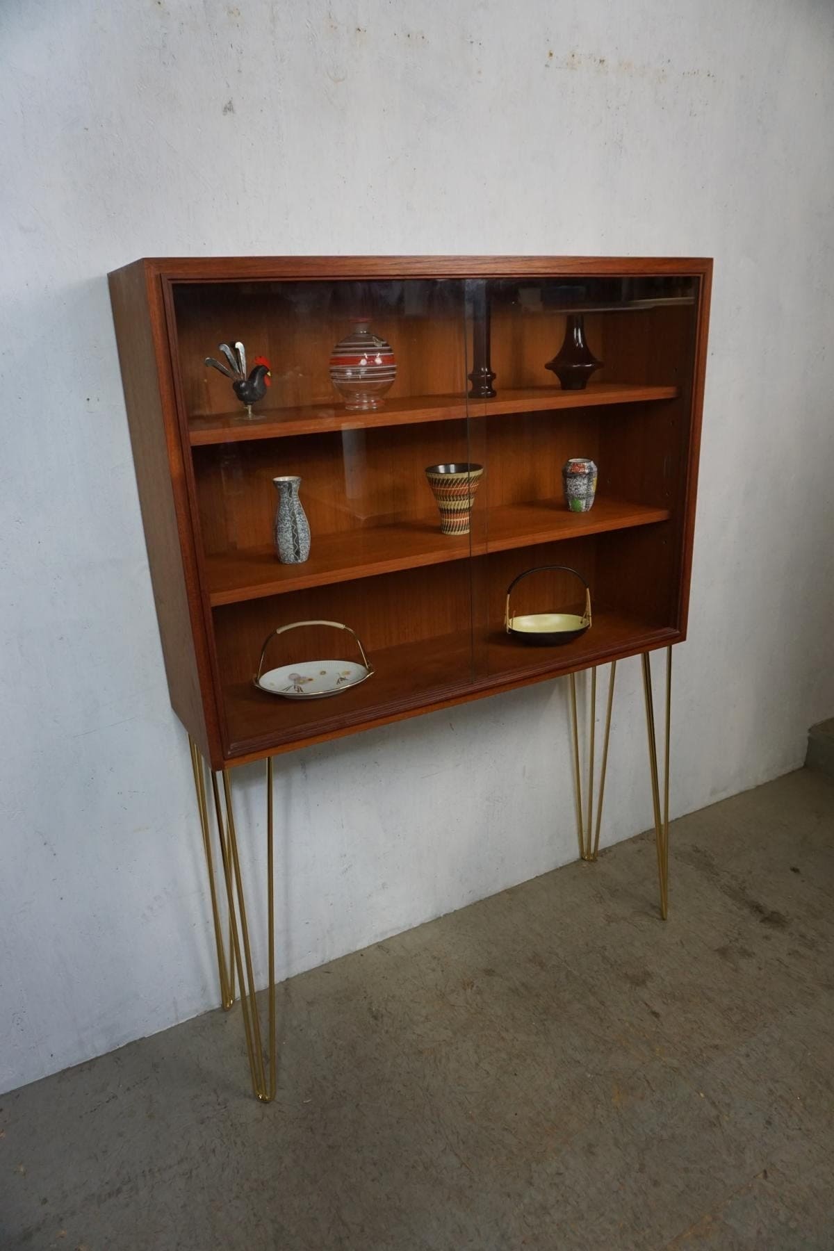 Noble teak display cabinet on golden hairpin legs vintage