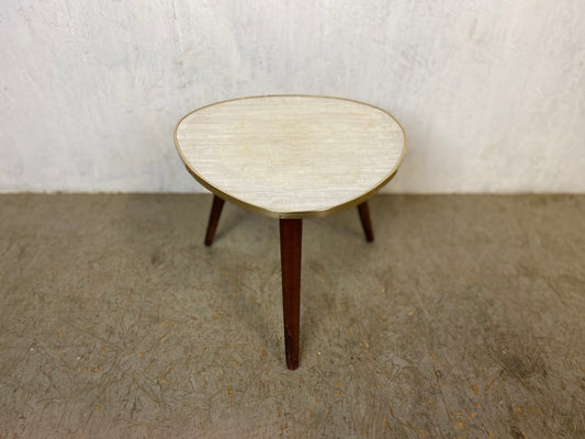 50s flower stool with three outward-facing wooden feet