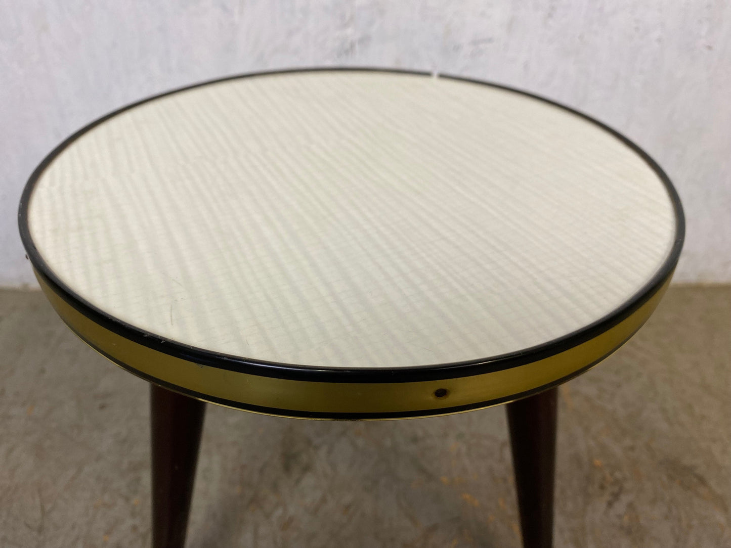 Round flower stool with brass edge and three outward-facing feet Vintage