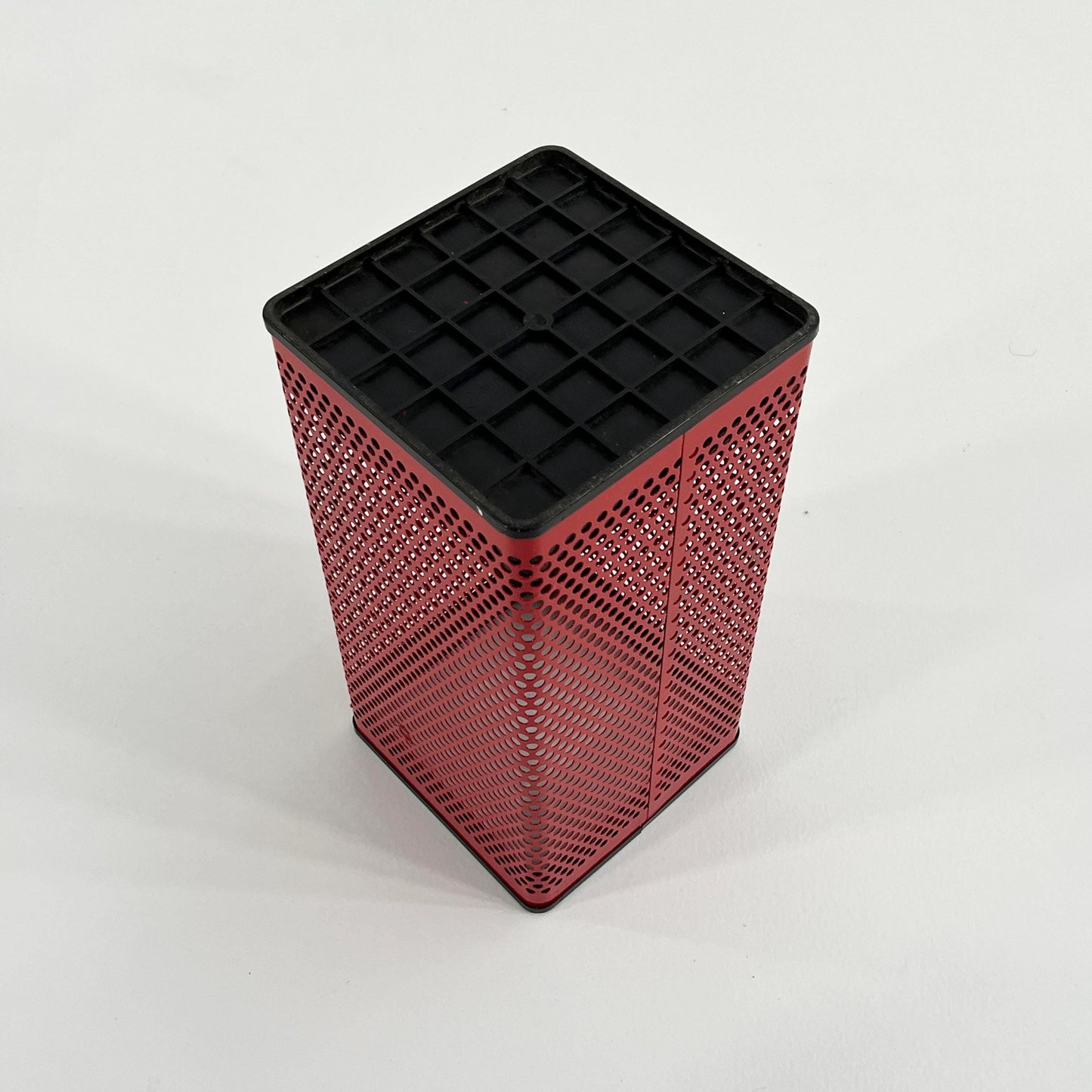 Red perforated trash can