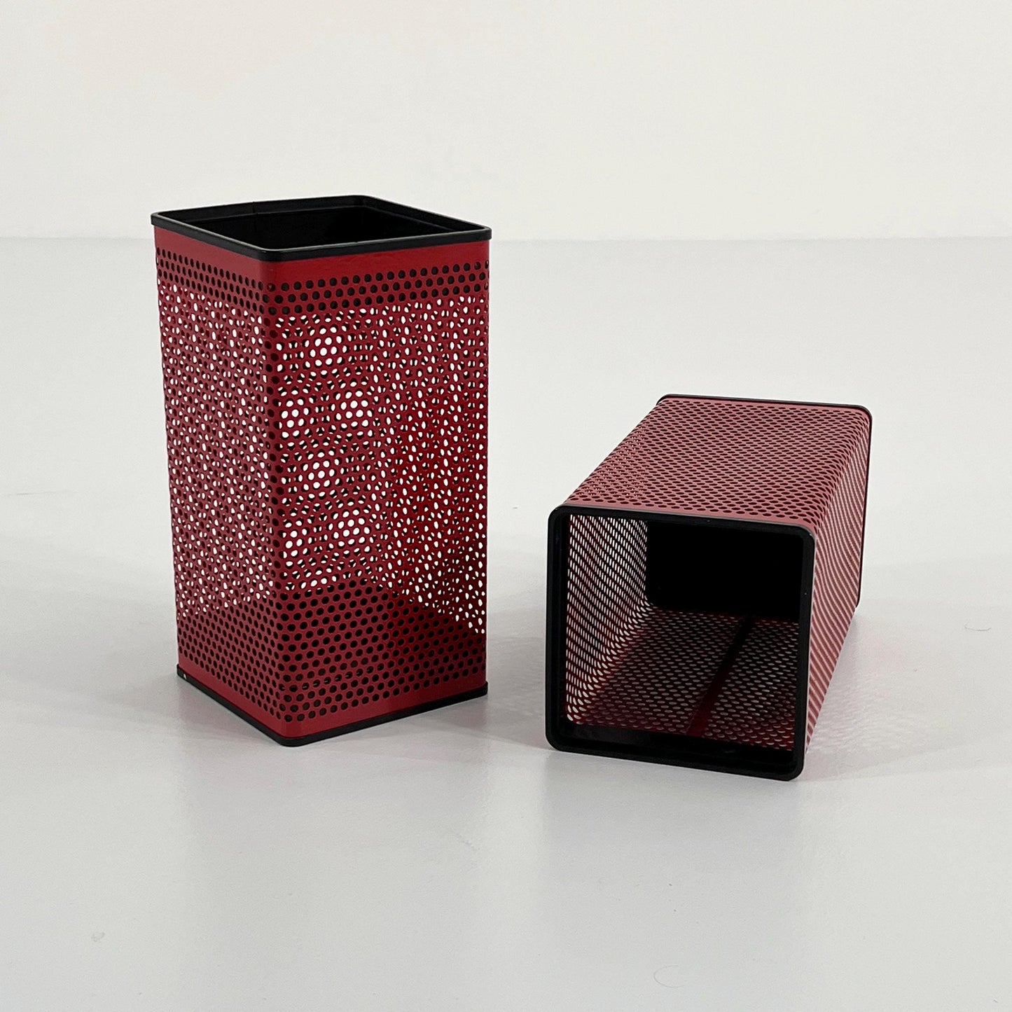 Red perforated trash can