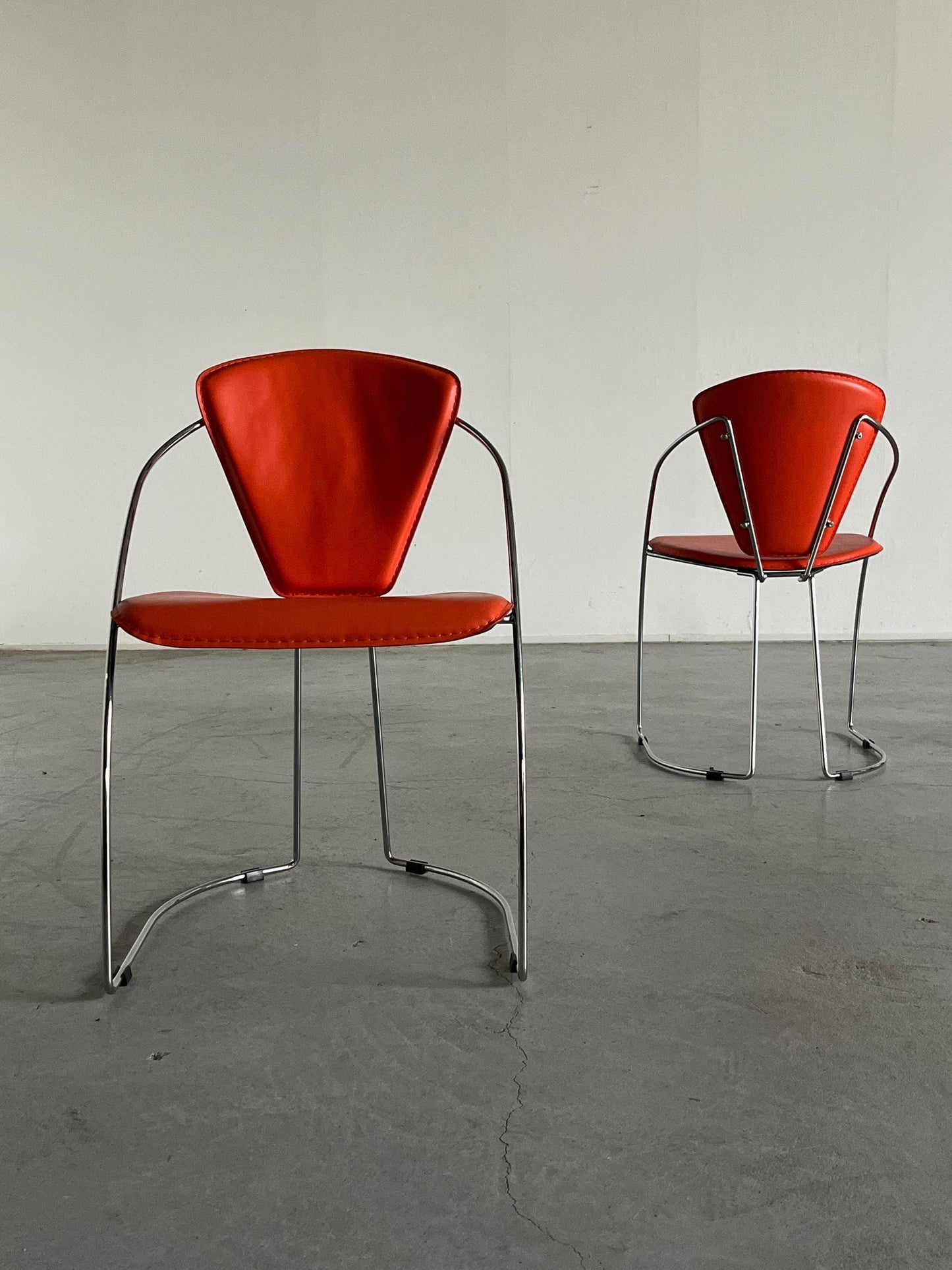 1 of 2 Postmodern orange dining chairs in the style of the Linda chair by Arrben, imitation leather and chromed steel, 1990s Italy