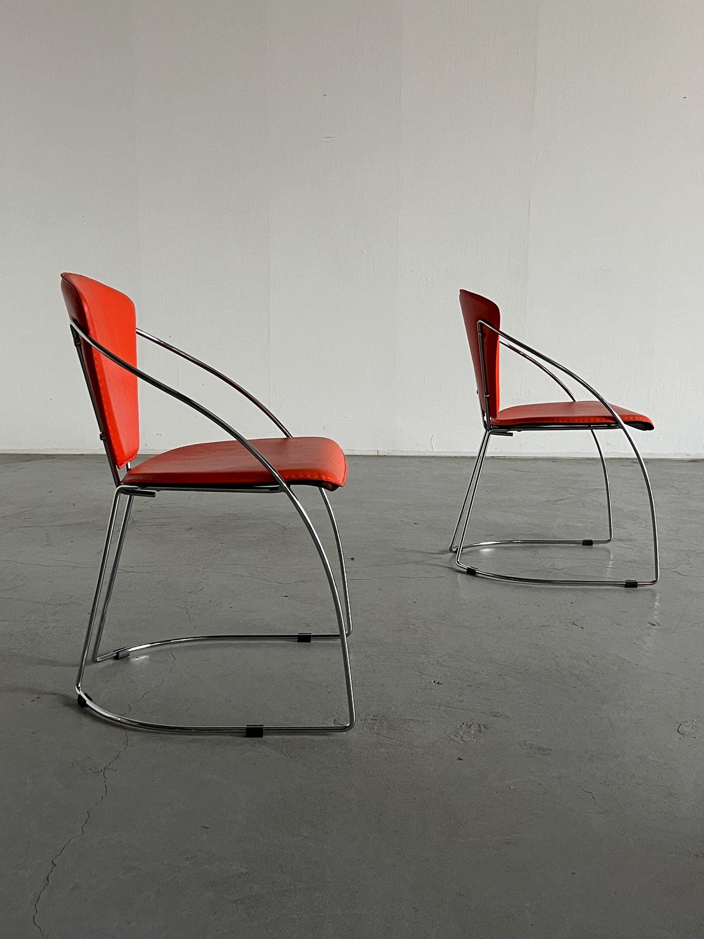 1 of 2 Postmodern orange dining chairs in the style of the Linda chair by Arrben, imitation leather and chromed steel, 1990s Italy