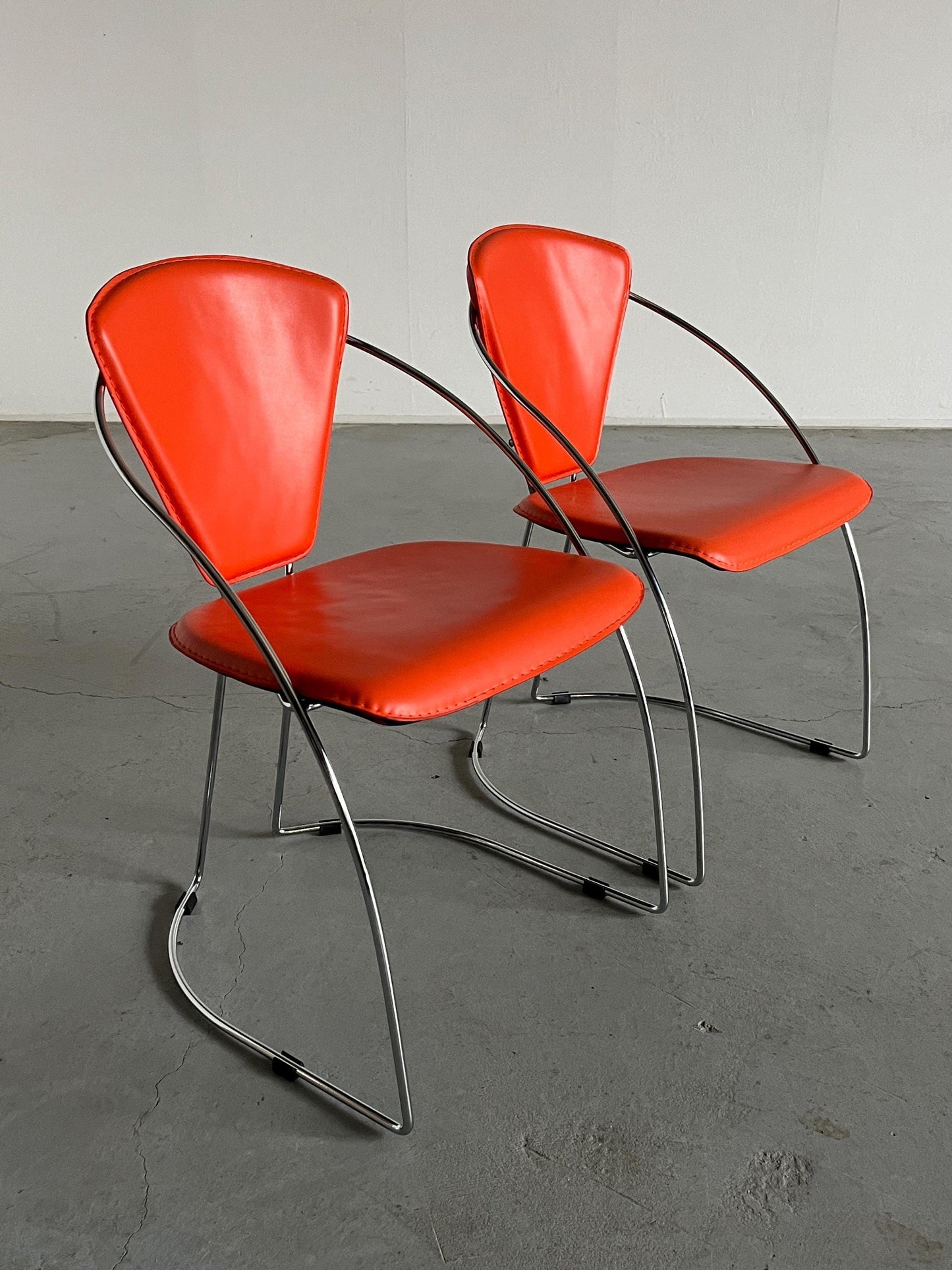 1 of 2 Postmodern orange dining chairs in the style of the Linda chair by Arrben, imitation leather and chromed steel, 1990s Italy