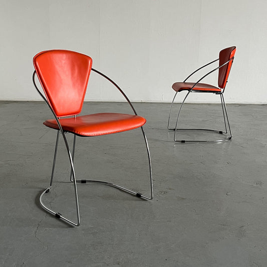 1 of 2 Postmodern orange dining chairs in the style of the Linda chair by Arrben, imitation leather and chromed steel, 1990s Italy