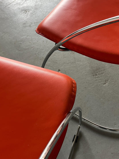 1 of 2 Postmodern orange dining chairs in the style of the Linda chair by Arrben, imitation leather and chromed steel, 1990s Italy