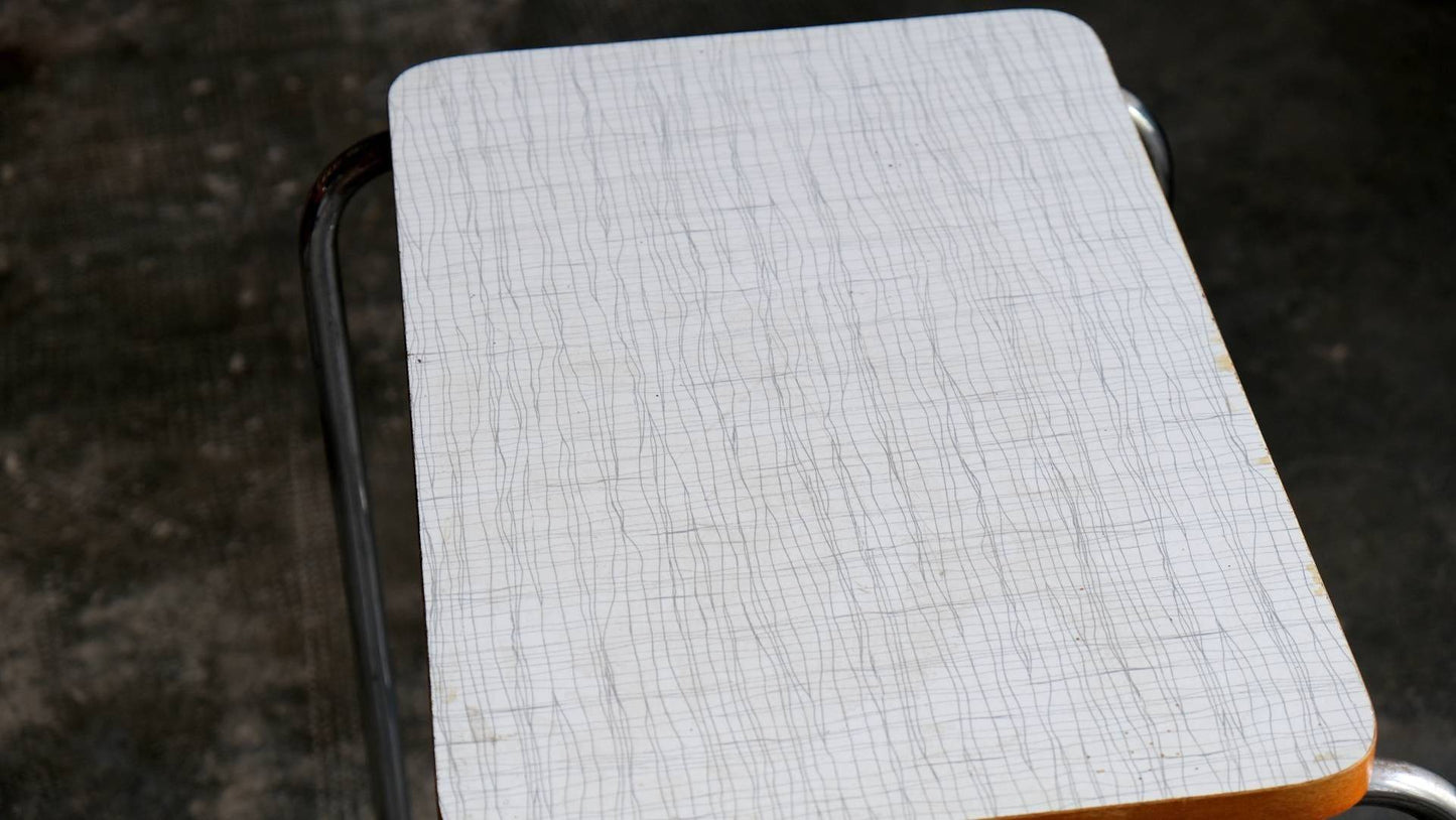 Steel tube side table with white Bakelite top