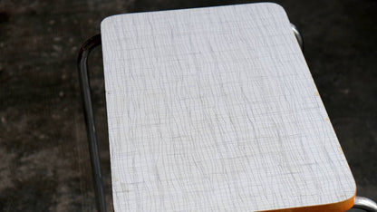 Steel tube side table with white Bakelite top